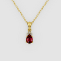 Lottie – Pear Ruby Solitaire Drop Pendant with Moissanite Accent in 18KT Gold