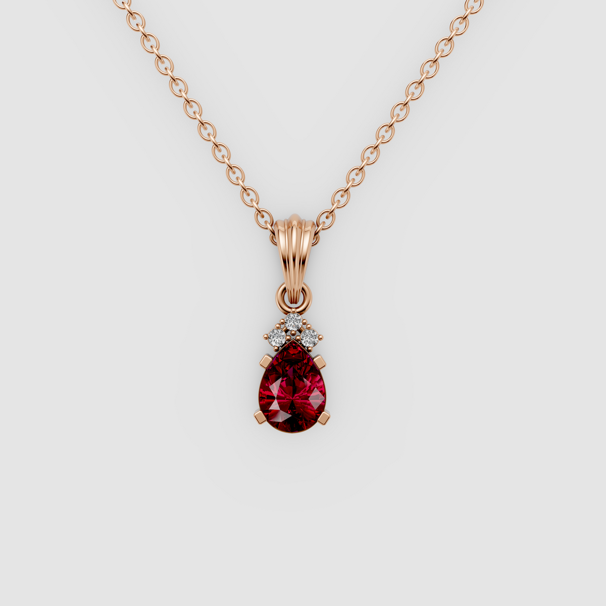 Lottie – Pear Ruby Solitaire Drop Pendant with Moissanite Accent in 18KT Gold