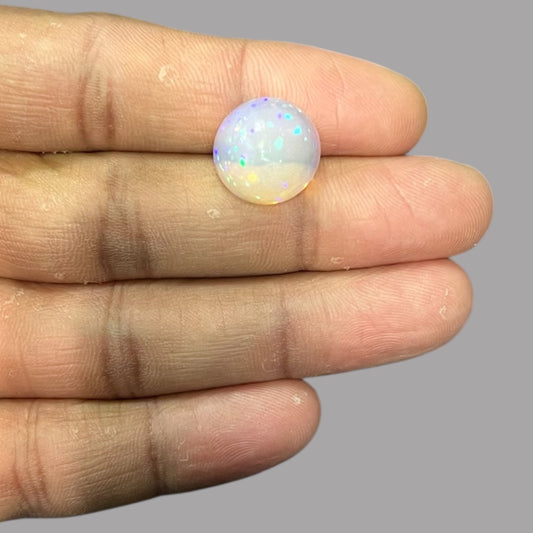 Natural Black Ethiopian Opal Stone 7.87 Carats Round Cabochon Shape Size 14.6 x 8.6 mm
