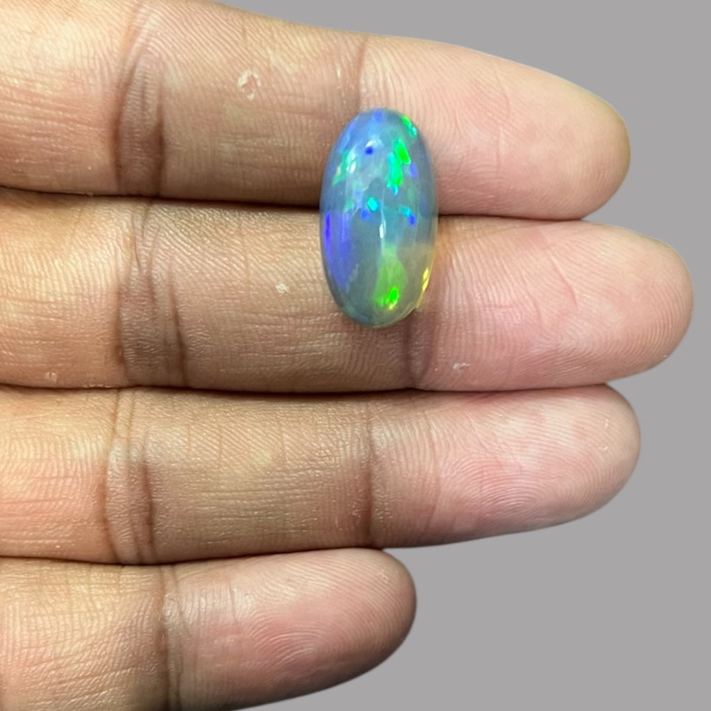 Natural Black Ethiopian Opal Stone 9.06 Carats Oval Cabochon Shape Size 20.3 x 11 x 7.4 mm