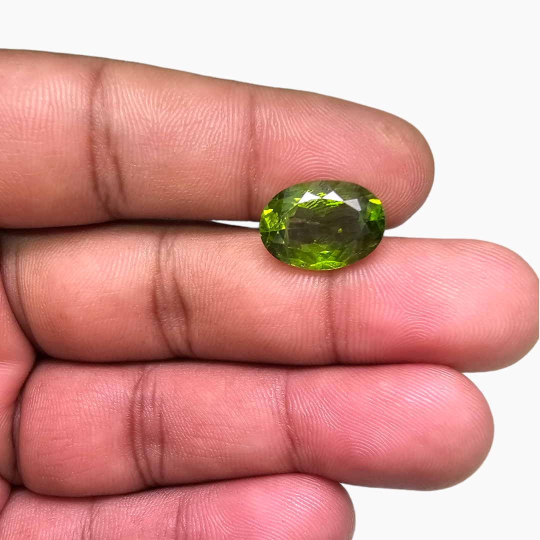 for sale Natural Peridot Stone 8.45 Carats Oval Cut Shape ( 14x10 mm )